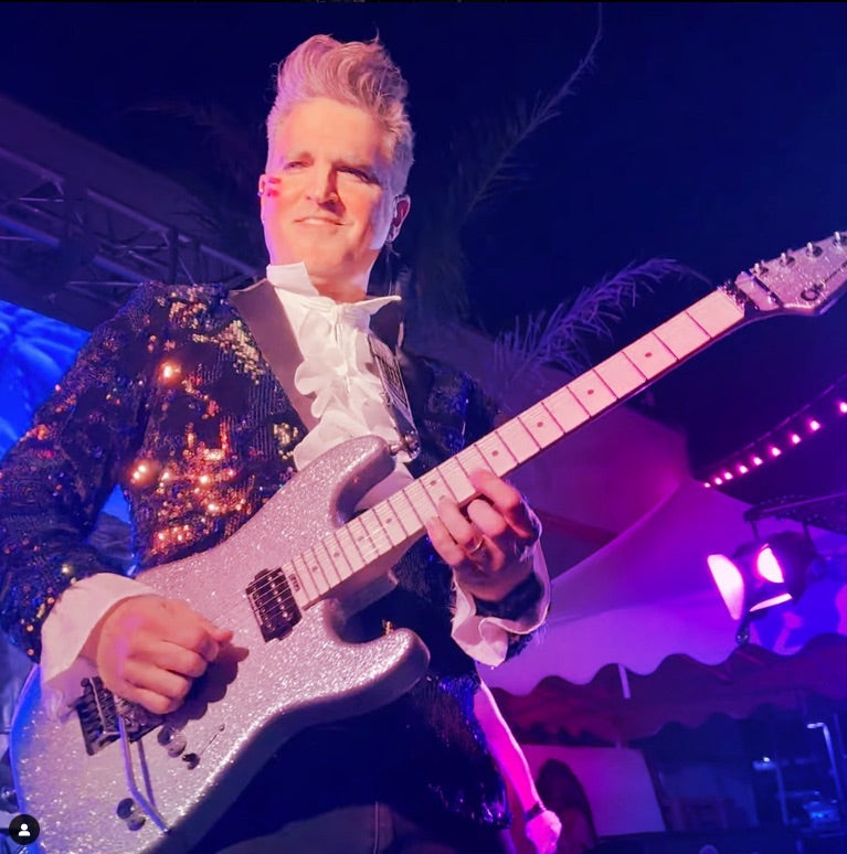 Eric Kuehnl performing guitar onstage
